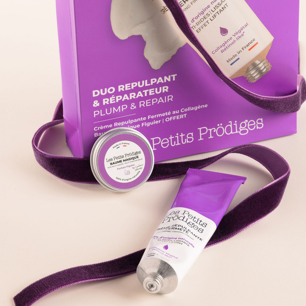 Duo Repulpant & Réparateur Les Petits Prödiges, avec la Crème Repulpante Fermeté et le Baume Magique Figuier devant leur coffret violet.
